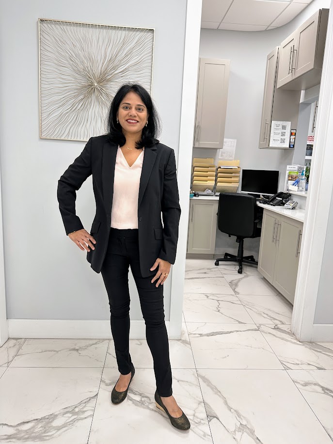Dr. Prathima Adusumilli standing in the office